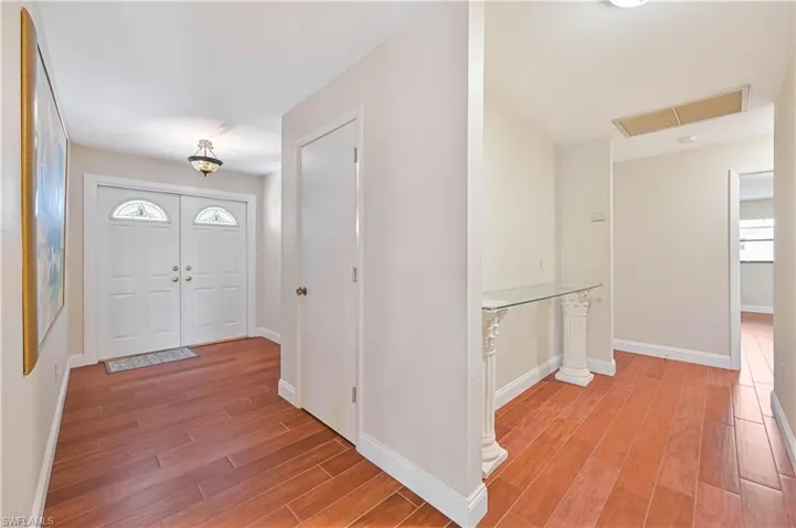 Foyer entrance with baseboards and wood-style Tile flooring