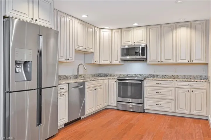 Kitchen with stainless steel appliances, recessed lighting, Granite counters, and Tile floors