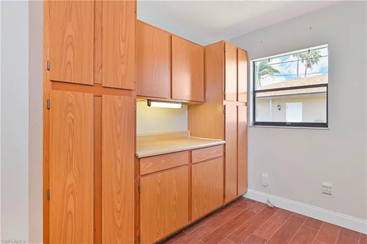 Laundry Room with wood-look tiled floors, light countertops, and a textured ceiling