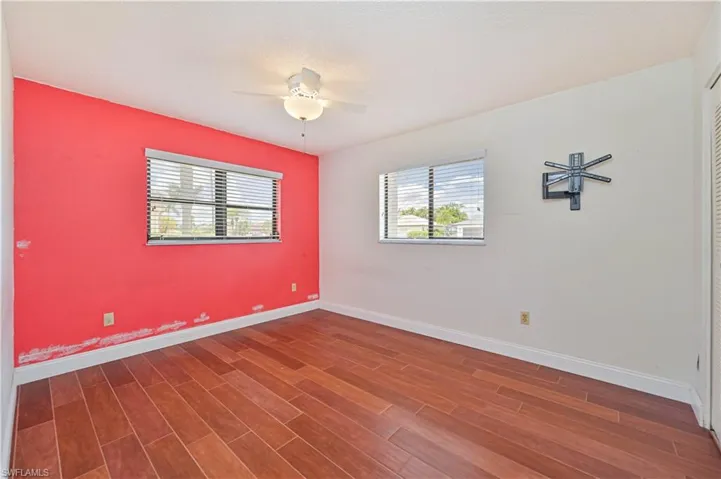 Spare room with dark wood-look tile flooring and a ceiling fan
