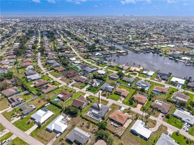 Aerial overview of property's location featuring a large body of water and nearby suburban area