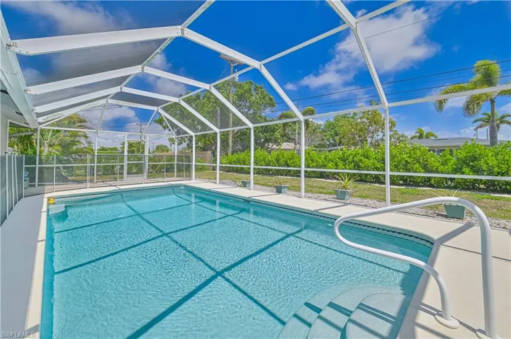 Sparkling solar-heated pool with privacy wall.true Florida living.
