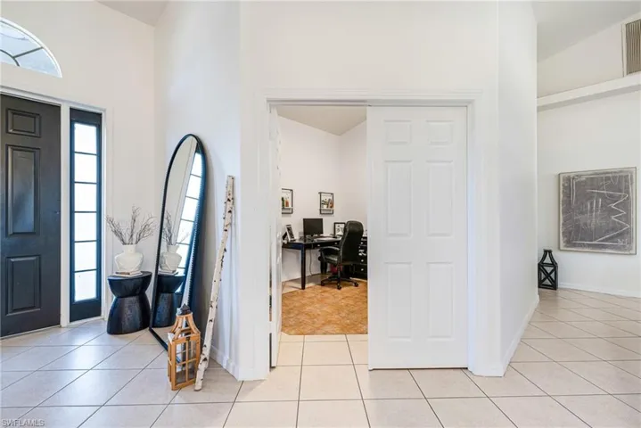 Foyer entrance featuring light tile patterned flooring
