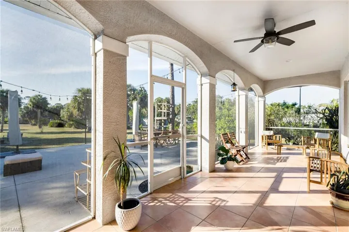 Unfurnished sunroom featuring tile patterned flooring, healthy amount of natural light, and a textured wall