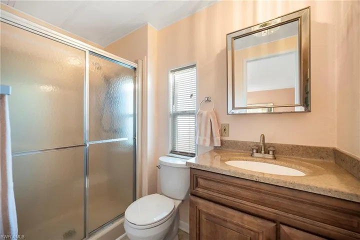 Full bathroom with vanity and a stall shower