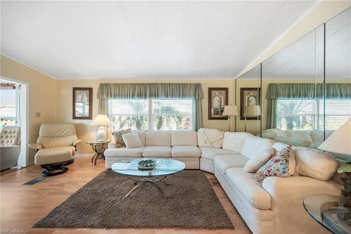 Living area featuring wood finished floors and ornamental molding