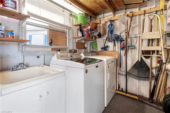 Washroom with separate washer and dryer and dark carpet