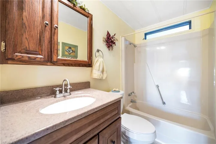 Bathroom featuring shower / washtub combination and vanity
