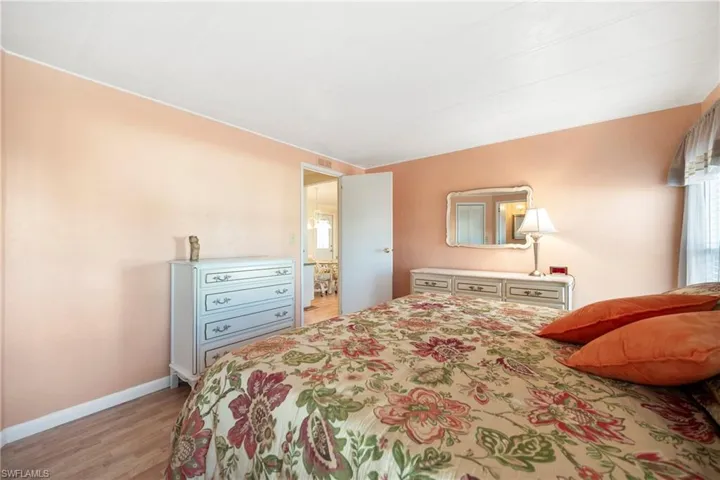 Bedroom with light wood-style floors and baseboards