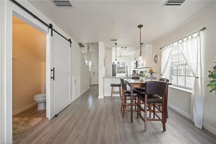 Open-concept living space with wood-finish flooring
