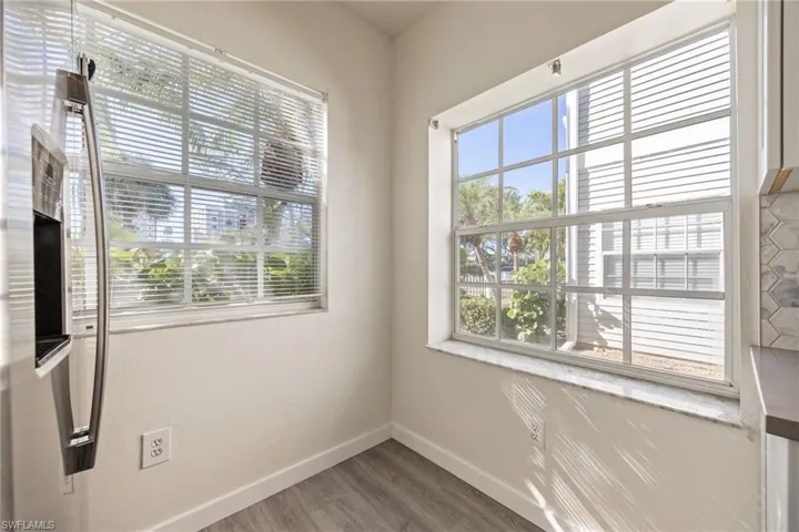 Corner windows featuring white frames, integrated blinds, and ample natural light
