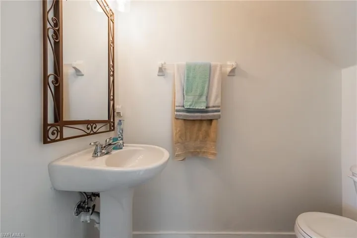 White pedestal sink with chrome faucet