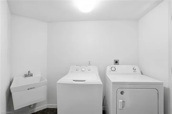 Laundry room featuring independent washer and dryer and baseboards