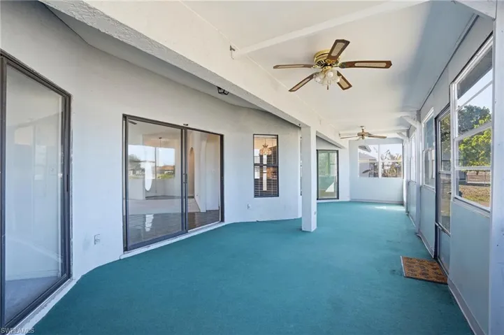 Unfurnished sunroom with ceiling fan