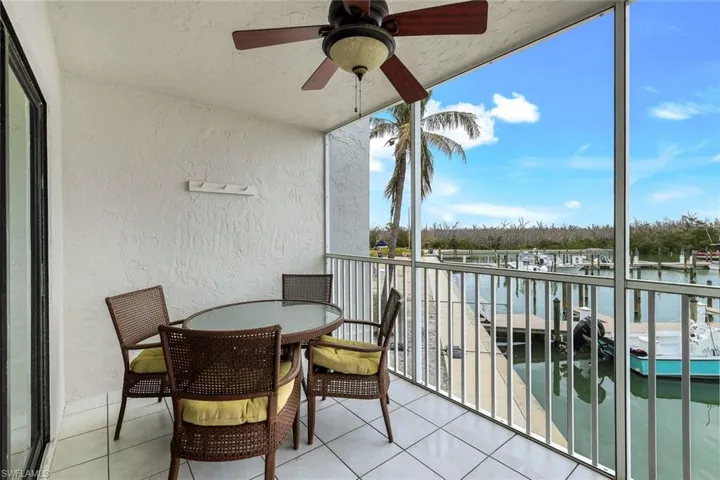 Balcony with a water view and ceiling fan