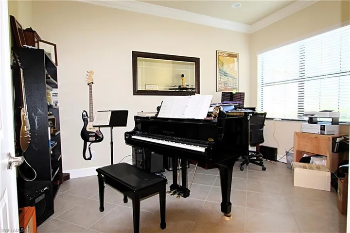 Miscellaneous room with light tile patterned floors and crown molding