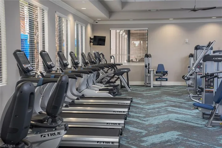 Workout area featuring carpet and crown molding