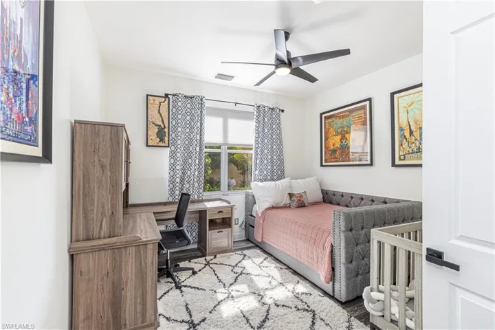 Bedroom featuring ceiling fan and light hardwood / wood-style flooring