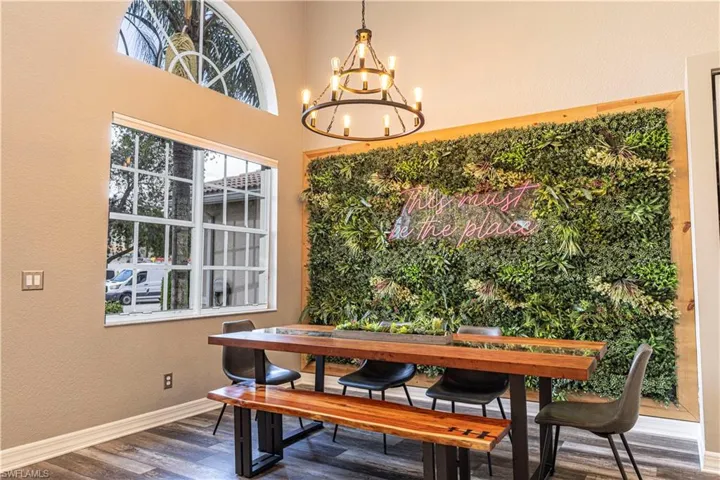Dining room featuring a notable chandelier, a high ceiling, and hardwood / wood-style flooring