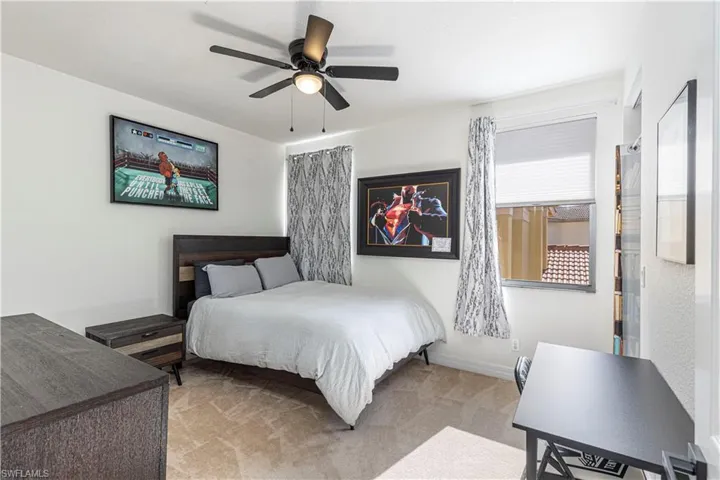 Bedroom featuring light colored carpet and ceiling fan