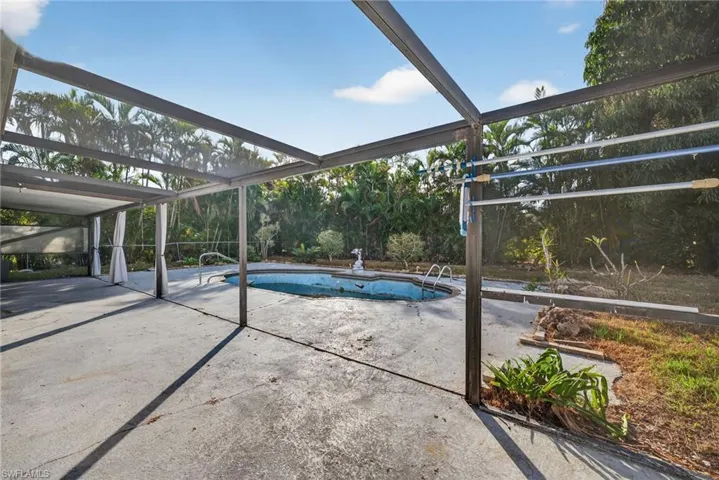 Swimming pool featuring a lanai and a patio