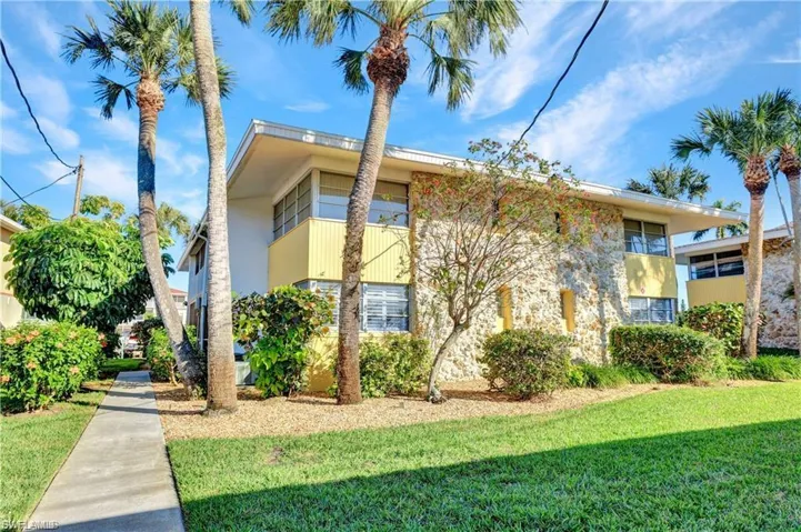 View of side of property with a lawn