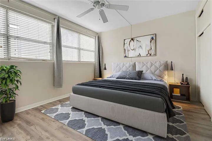 Bedroom with ceiling fan and hardwood / wood-style floors