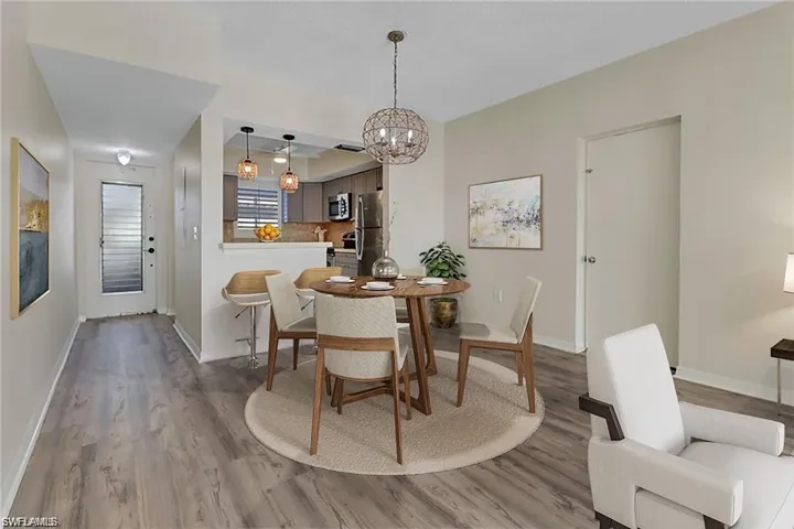 Dining room with hardwood / wood-style floors and a chandelier