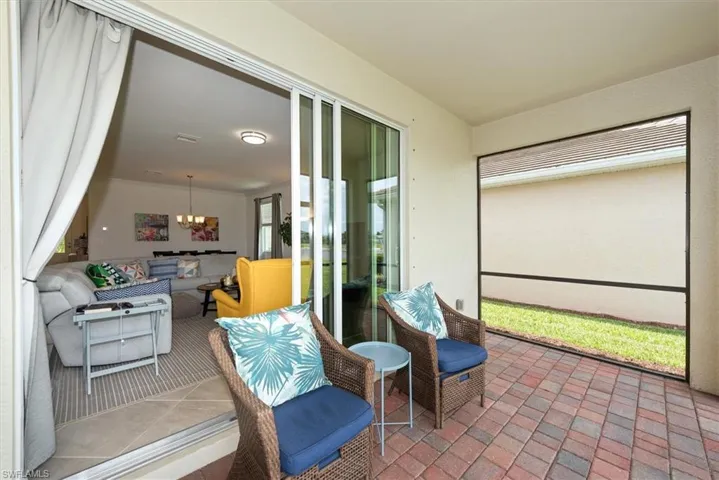 Covered patio featuring a brick paver floor and a screened enclosure