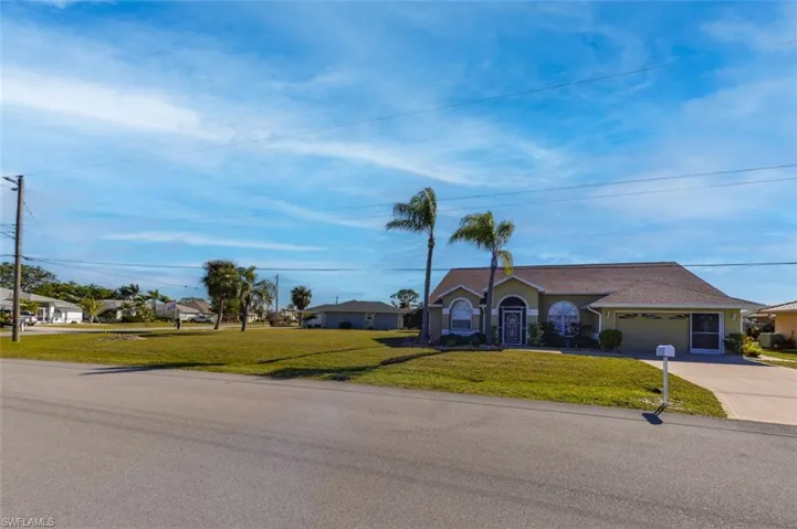 Oversized Lot, front corner extends to the left of photo toward corner. Screened entry. Sliding screens across garage opening. Newer (post Ian) shingle roof.