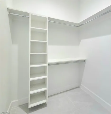 Spacious closet with light tile patterned floors