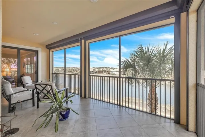 Balcony facing west, overlooking canal, tiled floor and electric shutter