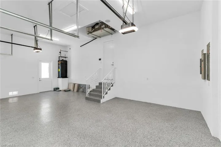 Garage with water heater and a garage door opener