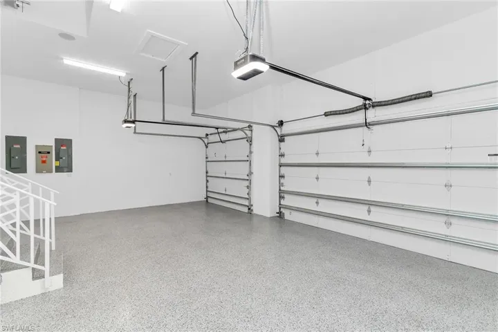 Garage featuring electric panel and a garage door opener