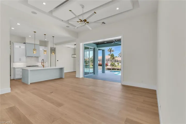 Unfurnished living room with light wood-type flooring, baseboards, and recessed lighting