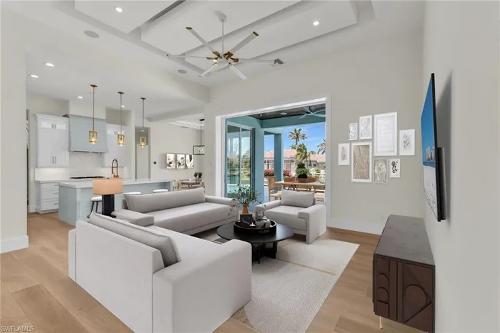 Virtually Staged - Living area featuring recessed lighting, light wood-style floors, baseboards, and ceiling fan