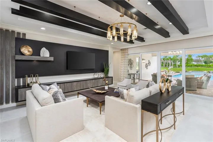 Living room with a chandelier and beam ceiling
