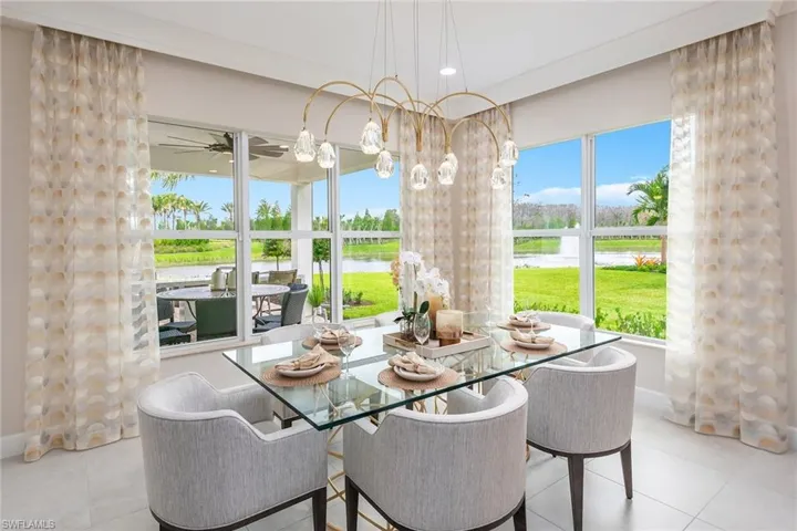 Tiled dining space with a water view and ceiling fan