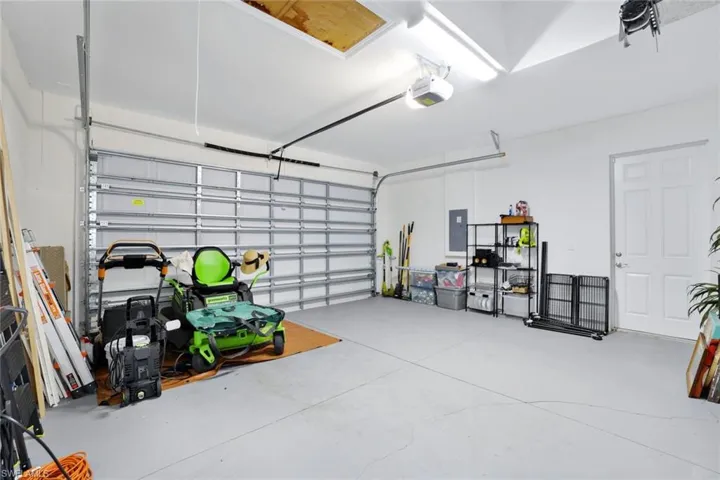 Garage with electric panel and a garage door opener