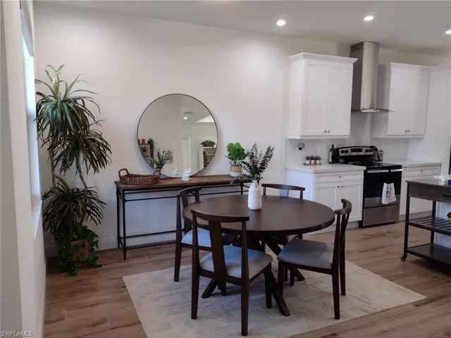 Dining space with recessed lighting and light wood finished floors