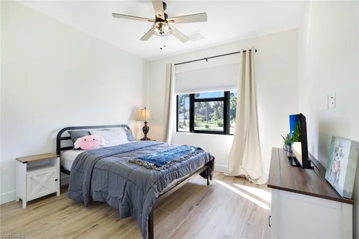 Bedroom with ceiling fan and light hardwood / wood-style flooring