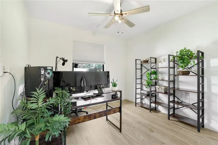 Office area with light hardwood / wood-style flooring and ceiling fan