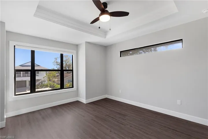 Unfurnished room featuring a wealth of natural light and a tray ceiling