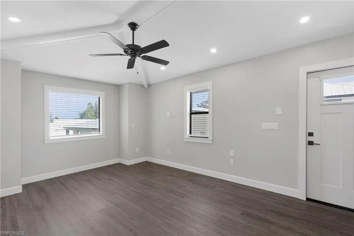 Spare room featuring ceiling fan and dark wood-type flooring