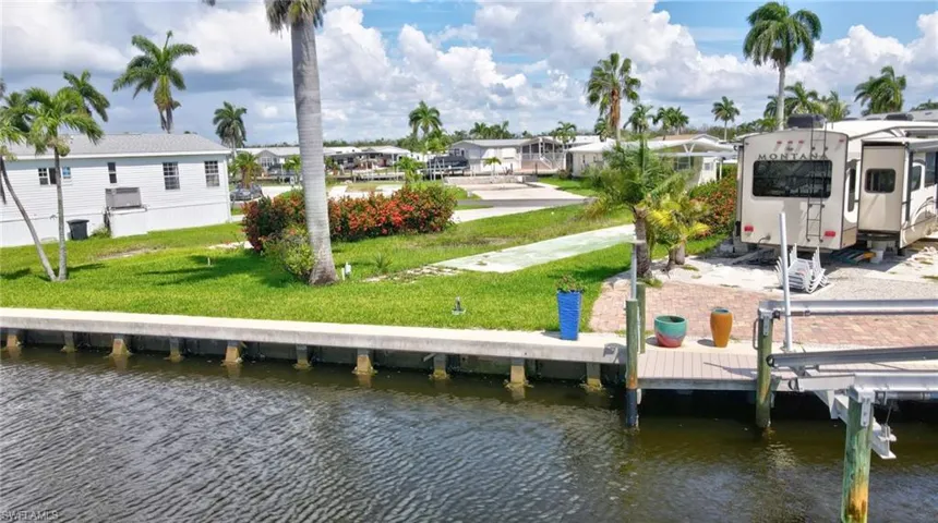 View of dock featuring a water view and a yard