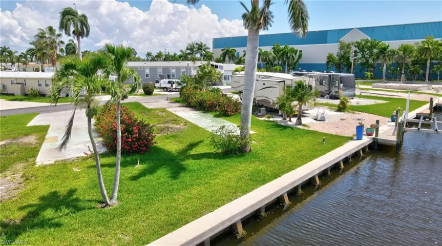 View of property's community with a water view and a yard