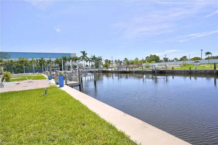 View of dock featuring a water view and a yard