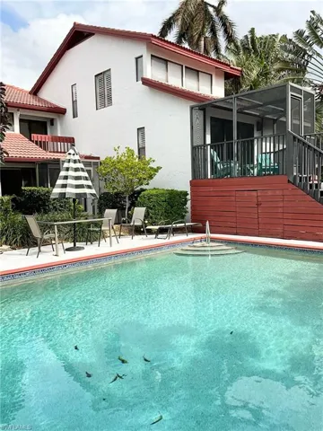 Pool with sitting area and BBQ grill.  Exit back of unit via he screened lanai and you are at the pool.