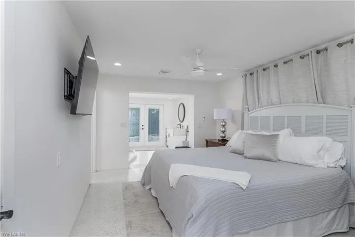 Bedroom with french doors, ceiling fan, recessed lighting, and speckled floor