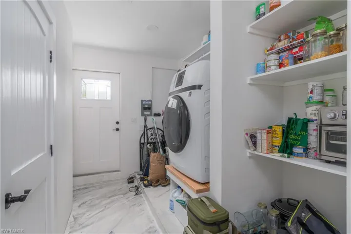 Washroom featuring washer / dryer